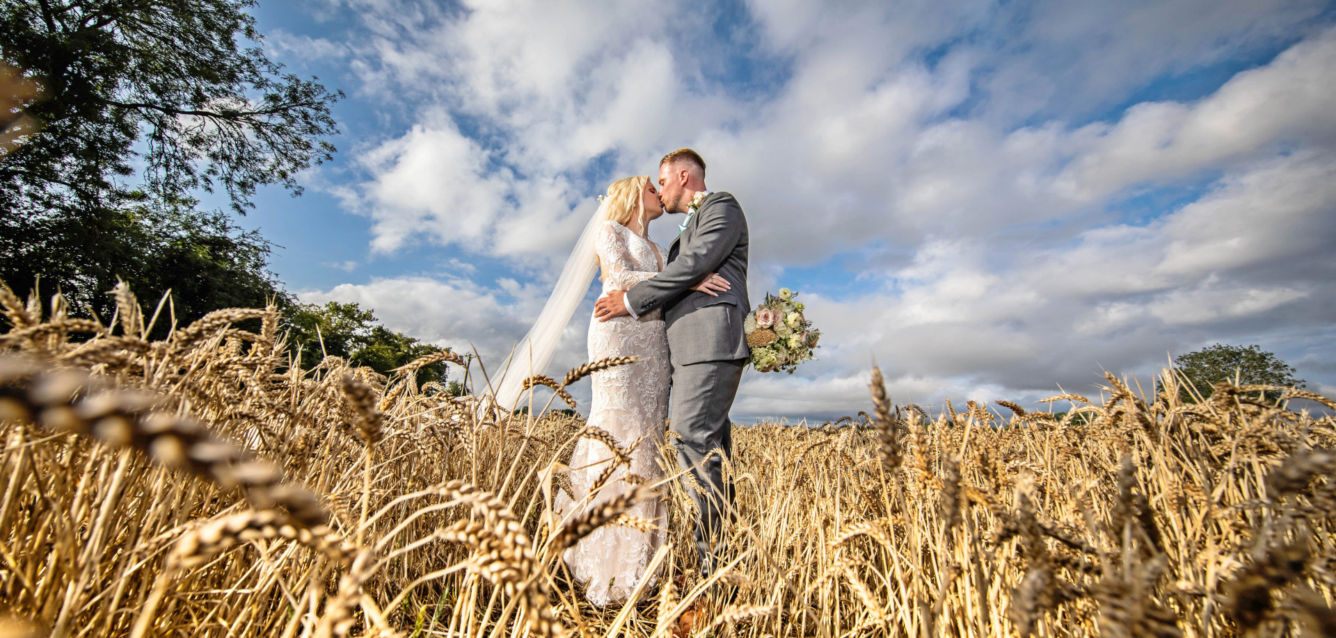 Bride and groom in corn field - Peter Rollings Photography, weddings, family portraits, studio and professional